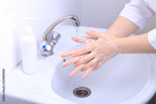A female doctor washes her hands thoroughly. Pandemic virus COVID-19