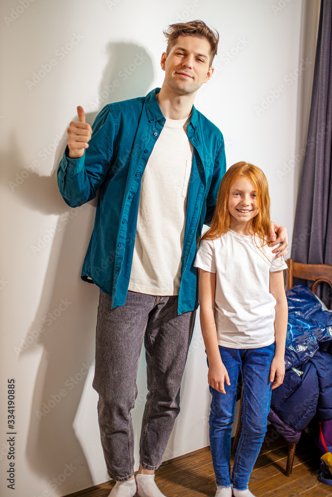 Happy caucasian bloggers stand together at home. beautiful enthusiastic brother and sister are bloggers. friendship, modern generation Happy caucasian bloggers stand together at home. beautiful enthusiastic brother and sister are bloggers. friendship, modern generation