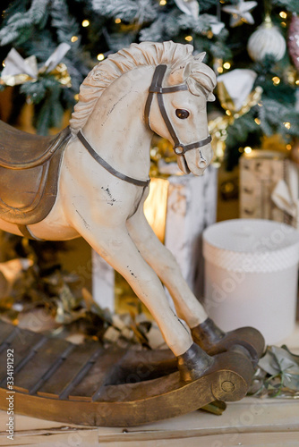 wooden rocking horse near christmas decor