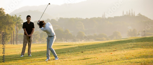 Asian man golfer playing golf with friend  at golf course