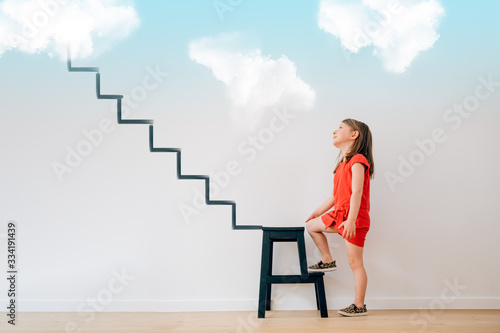 little girl begin to climb the stairs that lead to heaven - life future dreams targets goals illusions planning grow motivation concept photo