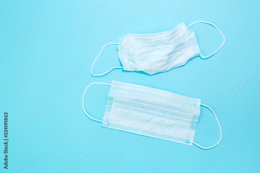 Protective medical mask, medical gloves and a sanitizer on a blue background. The first necessary protection for coronavirus. Covid-2019. Pandemic 2020. Protective medical mask, medical gloves and a sanitizer on a blue background. The first necessary protection for coronavirus. Covid-2019. Pandemic 2020.