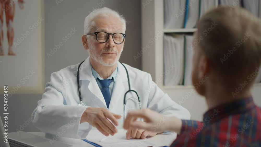 Doctor Shaking Hands With Male Patient In Office Doctor Shaking Hands With Male Patient In Office