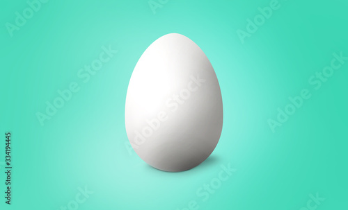 White Easter egg on turquoise pastel background. Happy Easter concept. 