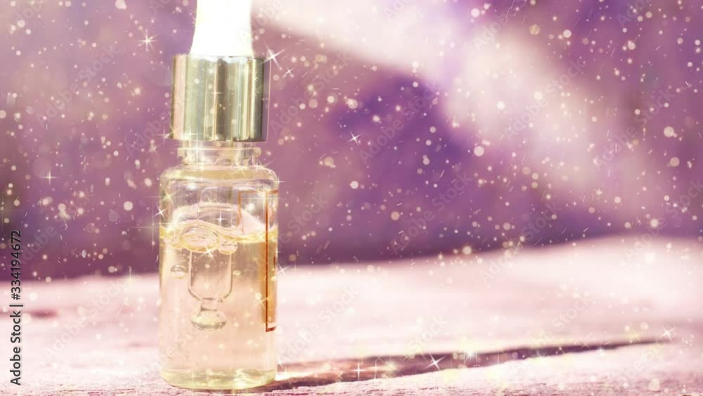 Cosmetic oil, facial emulsion, on a beautiful shining background. Cosmetic oil, facial emulsion, on a beautiful shining background.