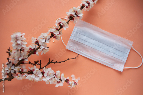 Spring 2020. Face mask. Ncov-19 protective anti-coronavirus. Cherry blossom branch.