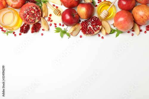 Apple, honey and pomegranate on white background, space for text