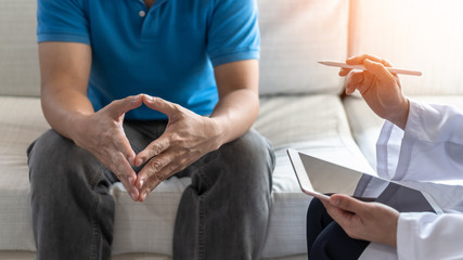 Men's health disease, on prostate cancer or mental illness concept with male patient having consultation with doctor or psychiatrist working on diagnostic examination in medical clinic or hospital