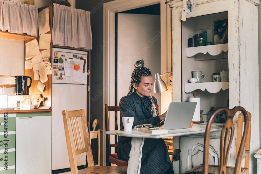 Adult woman indoor at home using computer