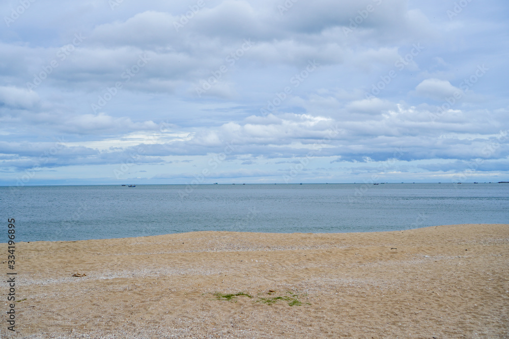 seascape, cloudy sky, blue sea and golden sand beach seascape, cloudy sky, blue sea and golden sand beach