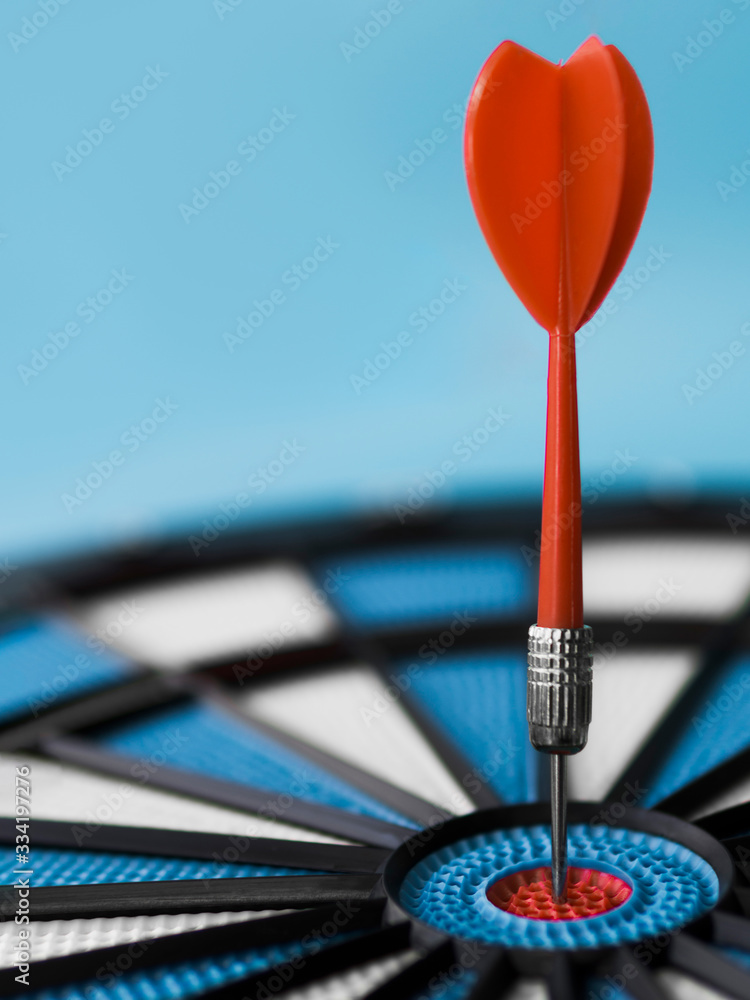 Fototapeta premium Close-up of dart stuck in bull's-eye with copy space