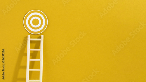 Front view of ladder with circular target and copy space