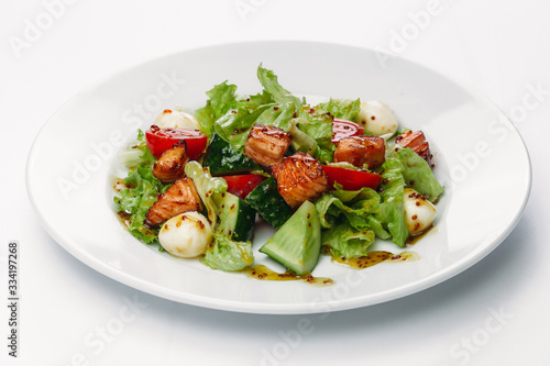 salad with egg on a plate on a white background