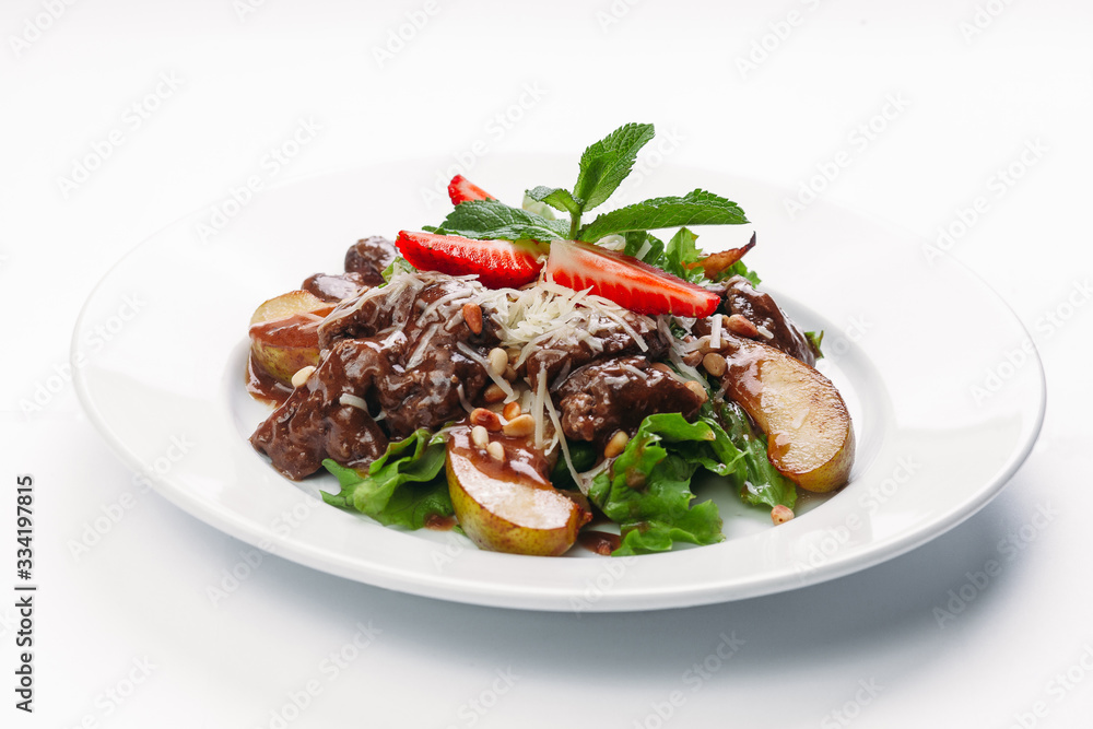 salad of pears, strawberries and greens on a white background salad of pears, strawberries and greens on a white background