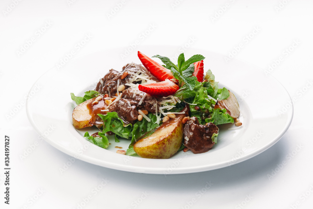 salad of pears, strawberries and greens on a white background salad of pears, strawberries and greens on a white background