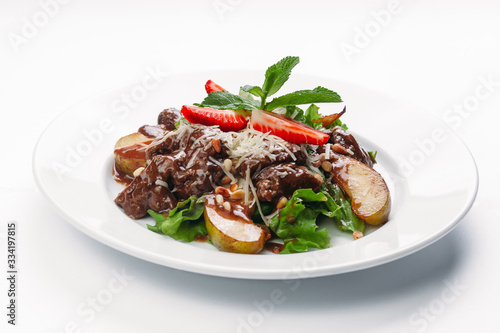 salad of pears, strawberries and greens on a white background