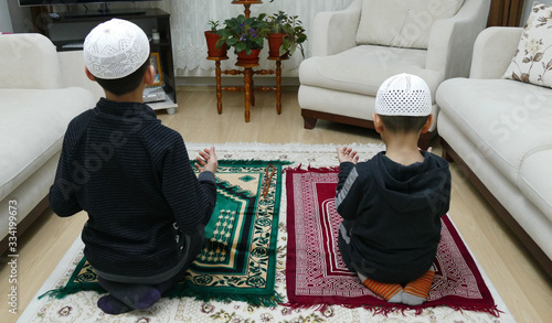 Photography two Muslim children who worship prayer,