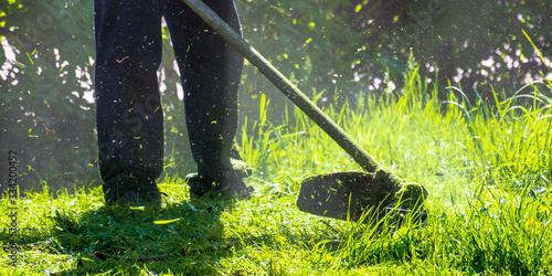 Obraz na płótnie lawn care maintenance. professional grass cutting in the yard w salonie