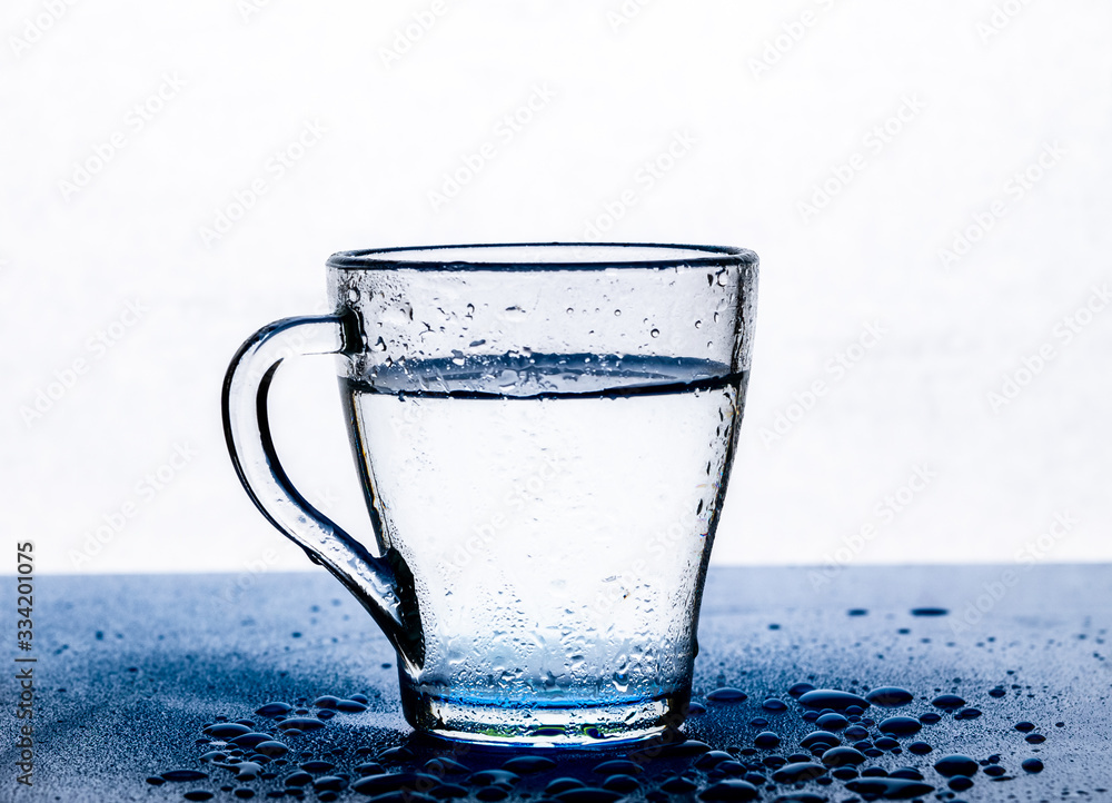 Clear Transparent Water In A Glass Cup On The Table On A White Background Drops Of Water On The Table Next To It Stock Photo Adobe Stock Clear Transparent Water In A Glass Cup On The Table On A White Background Drops Of Water On The Table Next To It Stock Photo Adobe Stock