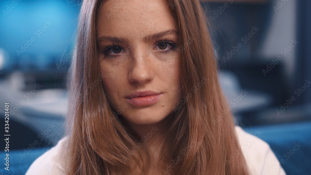Close up portrait of young dreaming charming red hair woman in white t-shirt with freckles open eyes and looks to camera in modern apartment feeling happy great evening good emitions home comfortable Close up portrait of young dreaming charming red hair woman in white t-shirt with freckles open eyes and looks to camera in modern apartment feeling happy great evening good emitions home comfortable