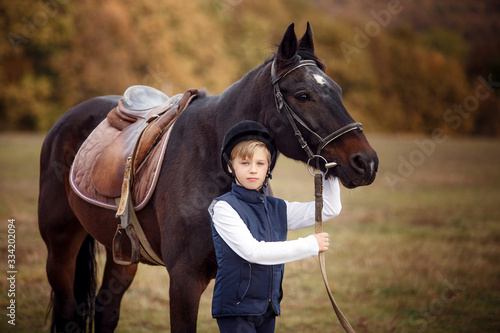 blond boy at the stable. Horseback Riding