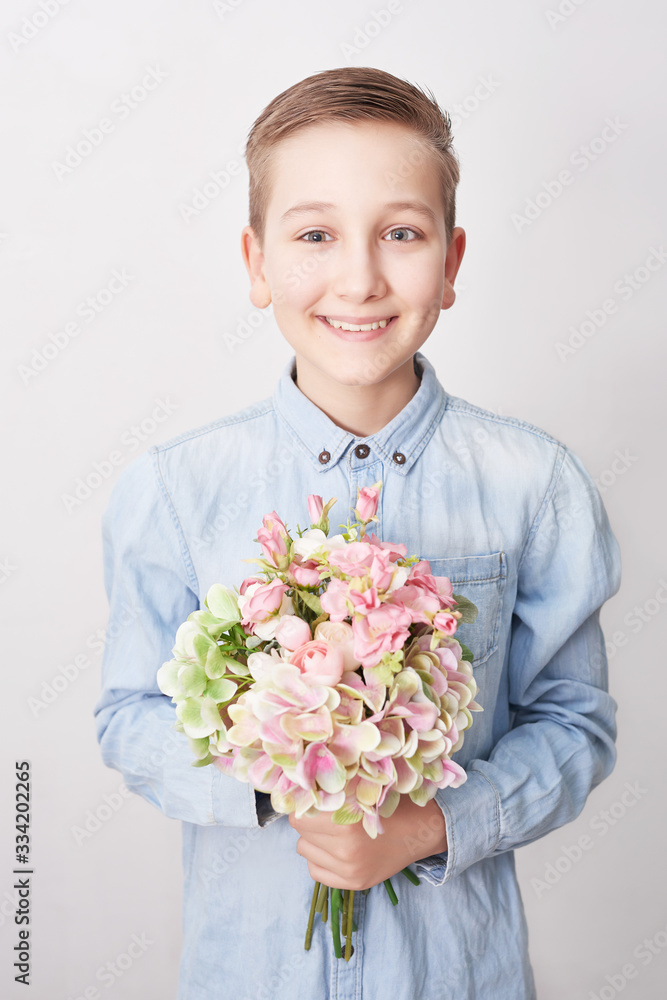Child boy with bouquet of flowers. Mother's Day Greeting Card. Happy mothers day frame background. Spring card template. Happy Birthday or Valentine. Women's Day. Copy space. Child gives bouquet Child boy with bouquet of flowers. Mother's Day Greeting Card. Happy mothers day frame background. Spring card template. Happy Birthday or Valentine. Women's Day. Copy space. Child gives bouquet