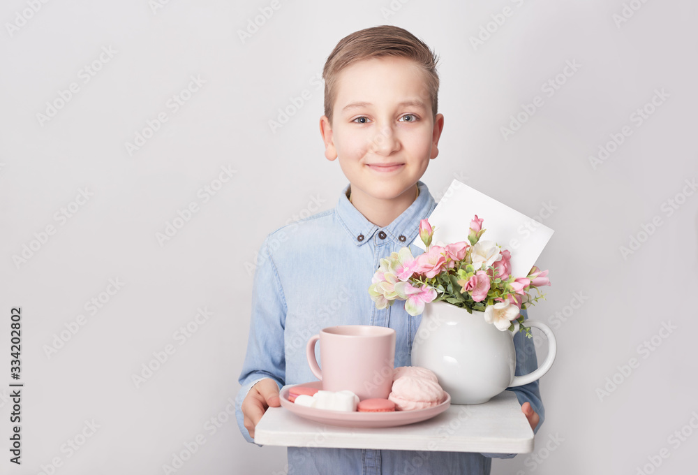 Child boy with breakfast. Mother's Day Greeting Card. Happy mothers day frame background. Spring card template. Happy Birthday or Valentine. Women's Day. Copy space. Child with flowers Child boy with breakfast. Mother's Day Greeting Card. Happy mothers day frame background. Spring card template. Happy Birthday or Valentine. Women's Day. Copy space. Child with flowers