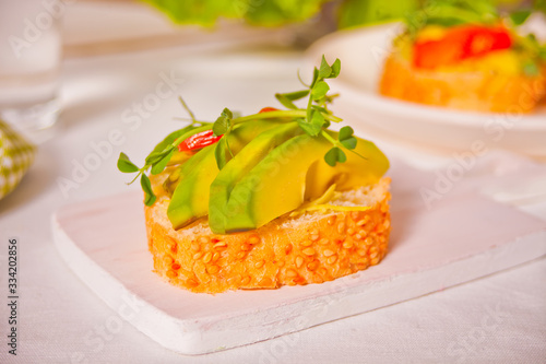 sliced avocado on toast bread with herbs.