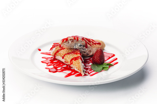 dessert of pancakes, ice cream, and fruit on a white background