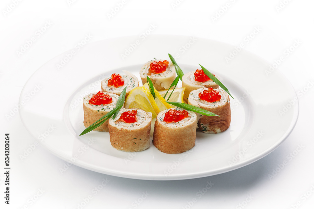 stuffed pancakes with caviar and lemon slices on a white background