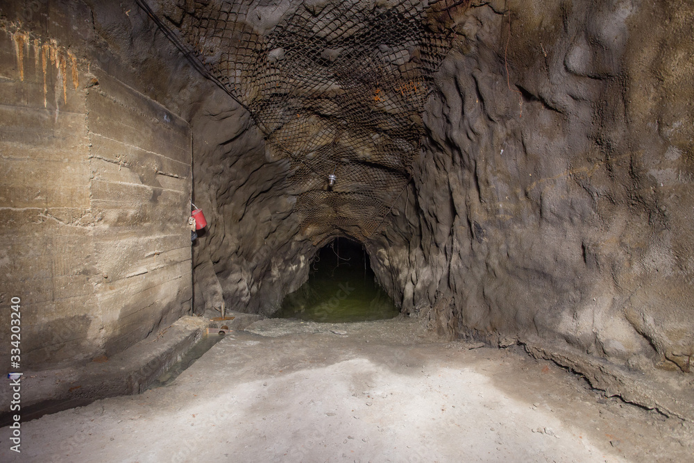 Underground gold mine tunnel settler pond