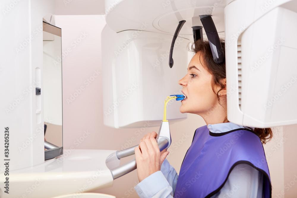 Woman as a patient at the x-ray at the dentist Woman as a patient at the x-ray at the dentist