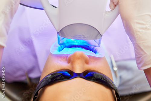 Blue LED light with teeth whitening at the dentist photo