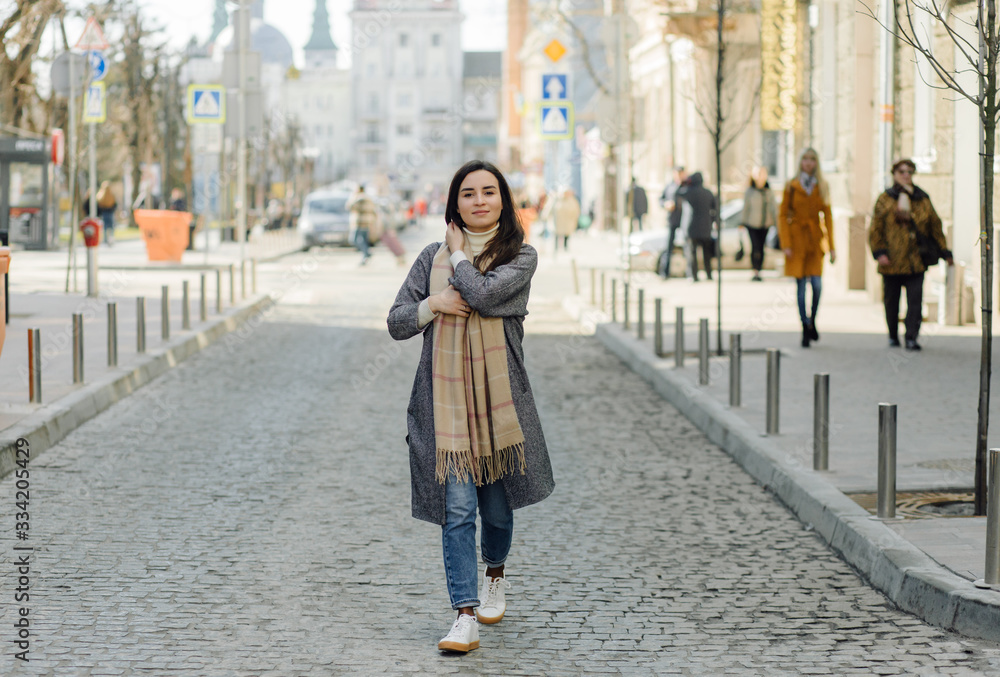 Fototapeta premium Woman portrait walking in the street