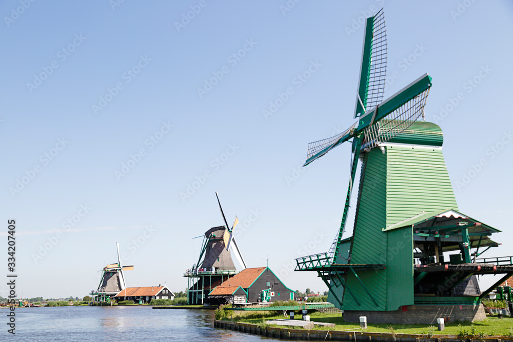 Several windmills of Zaanse Schans against blue sky, The Netherlands
