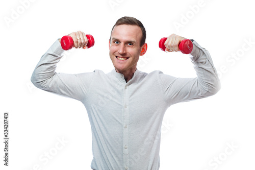 Caucasian man businessman, a teacher involved in sports. He is holding a red dumbbell. He is wearing a shirt. Emotional portrait. Isolated on white background © Дмитрий Ткачук