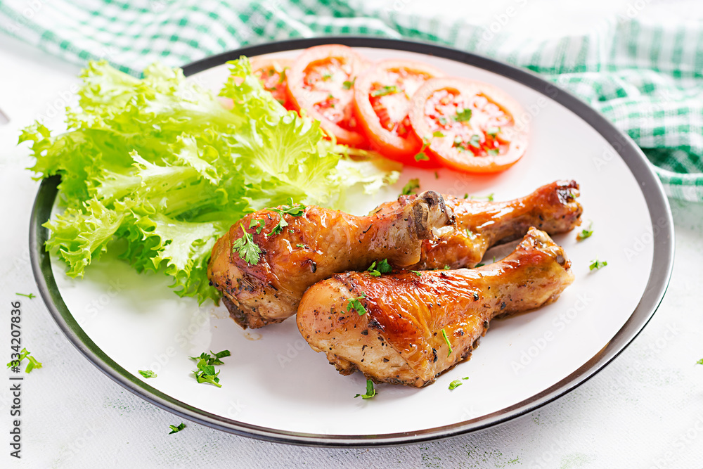 Grilled chicken legs with spices and fresh vegetables. Baked drumsticks. Grilled chicken legs with spices and fresh vegetables. Baked drumsticks.