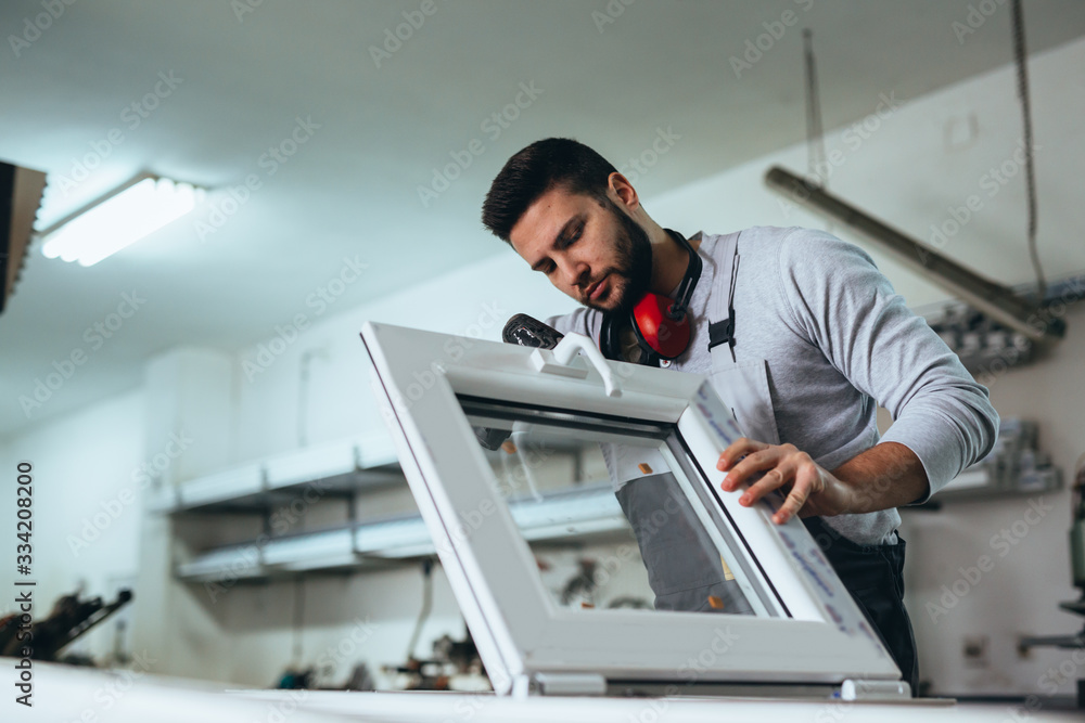 Aluminium and PVC industry worker making PVC or aluminium frames for windows and doors Aluminium and PVC industry worker making PVC or aluminium frames for windows and doors