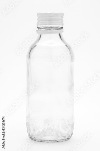A transparent glass bottle on a white background
