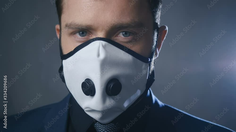 Close-up portrait of businessman in suit wearing medical mask during coronavirus covid-19 epidemic. Close-up portrait of businessman in suit wearing medical mask during coronavirus covid-19 epidemic.