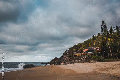 House in front of the beachin a cloudy day at Sayulita Beach, Nayarit, Mexico photo