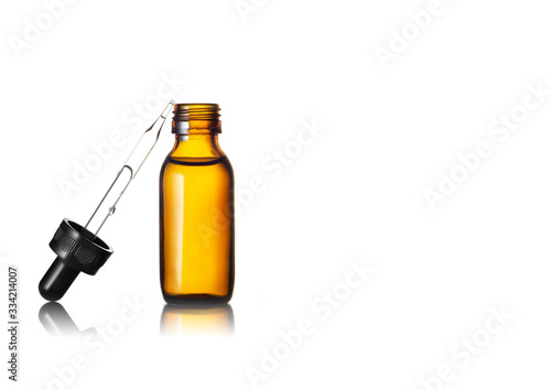 Serum or Essential oil in brown glass bottle on white background