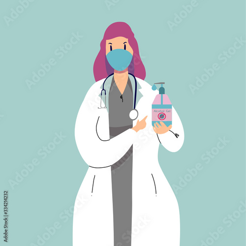 a woman doctor is recommended to use an alcohol gel.She is on isolate blue background.