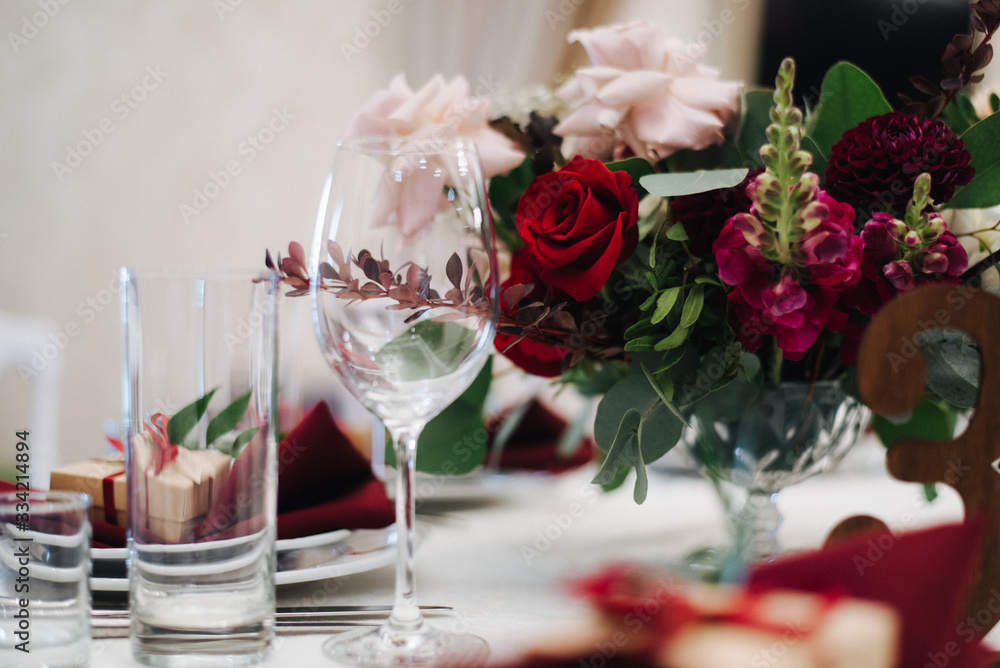 rose and wine glasses; elegant table setting; wedding table setting in red colors; сhristmas table setting rose and wine glasses; elegant table setting; wedding table setting in red colors; сhristmas table setting