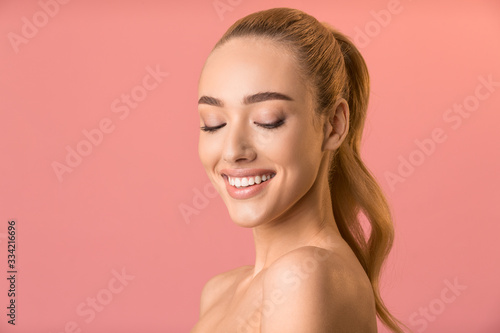 Young Woman Smiling Posing Naked In Studio, Empty Space