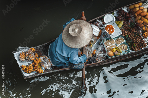 Photography Man on boat in Damnoen Saduak Floating Market in Bangkok Thainland