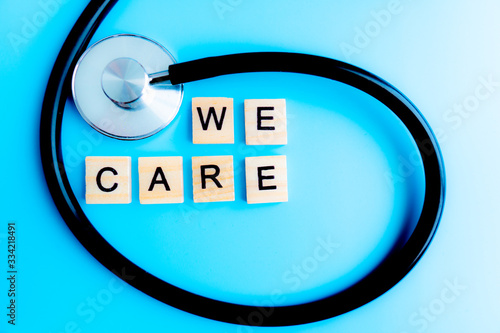 Stethoscope and We Care sign family concept on blue background, Health Insurance Concepts