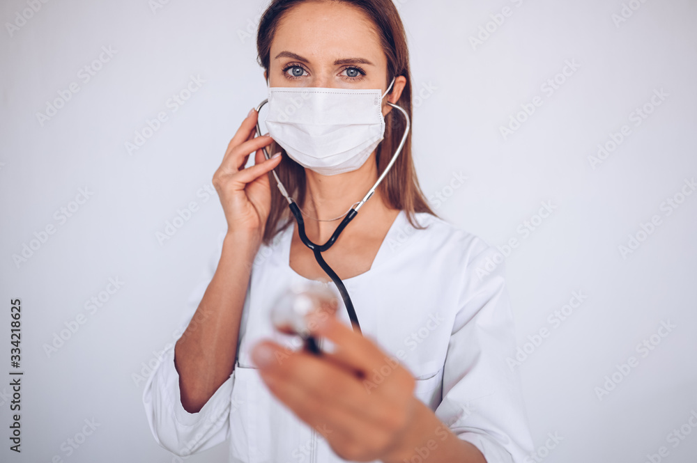 Woman doctor nurse wearing protective mask and stethoscope for check breathing, corona virus prevention, hygiene to stop spreading coronavirus. Avoid contaminating Corona virus Covid-19 concept Woman doctor nurse wearing protective mask and stethoscope for check breathing, corona virus prevention, hygiene to stop spreading coronavirus. Avoid contaminating Corona virus Covid-19 concept