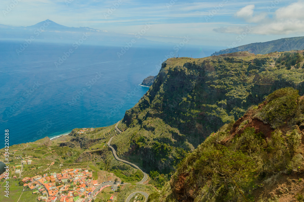 Views of Mount Teide, a village and a cliff from the glass interior of the Mirador de Abrante on the island of La Gomera. April 15, 2019. La Gomera, Santa Cruz de Tenerife Spain Africa. Travel