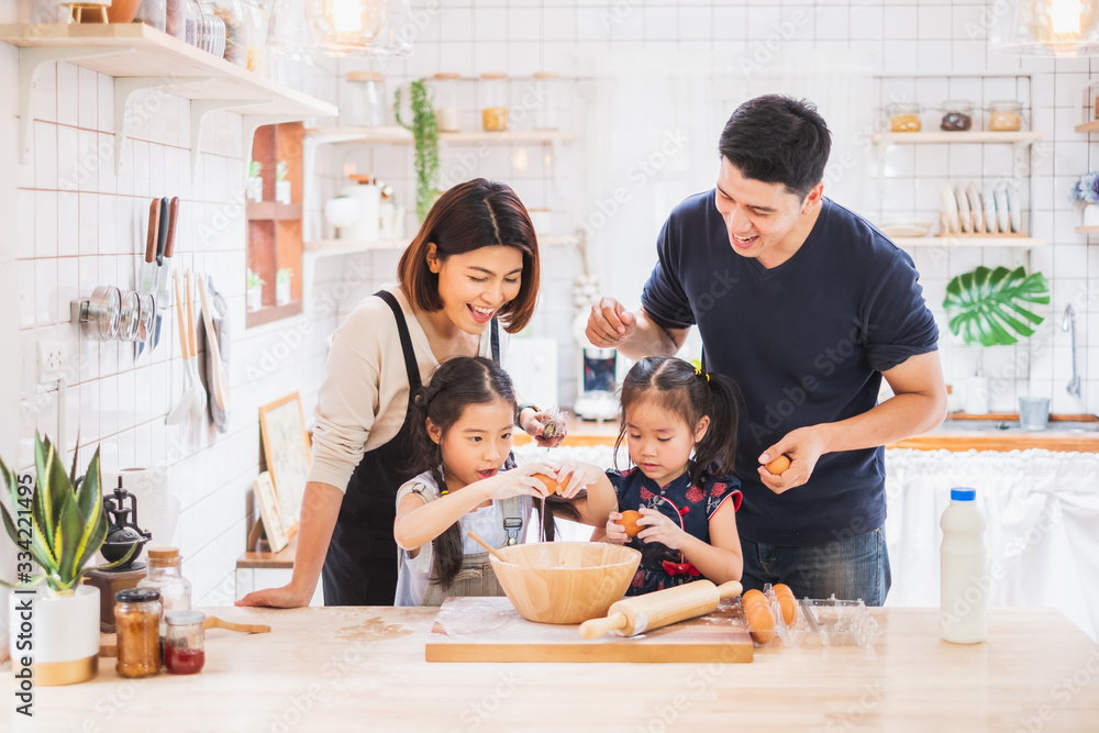 Asian family enjoy playing and cooking food in kitchen at home - obrazy, fototapety, plakaty 